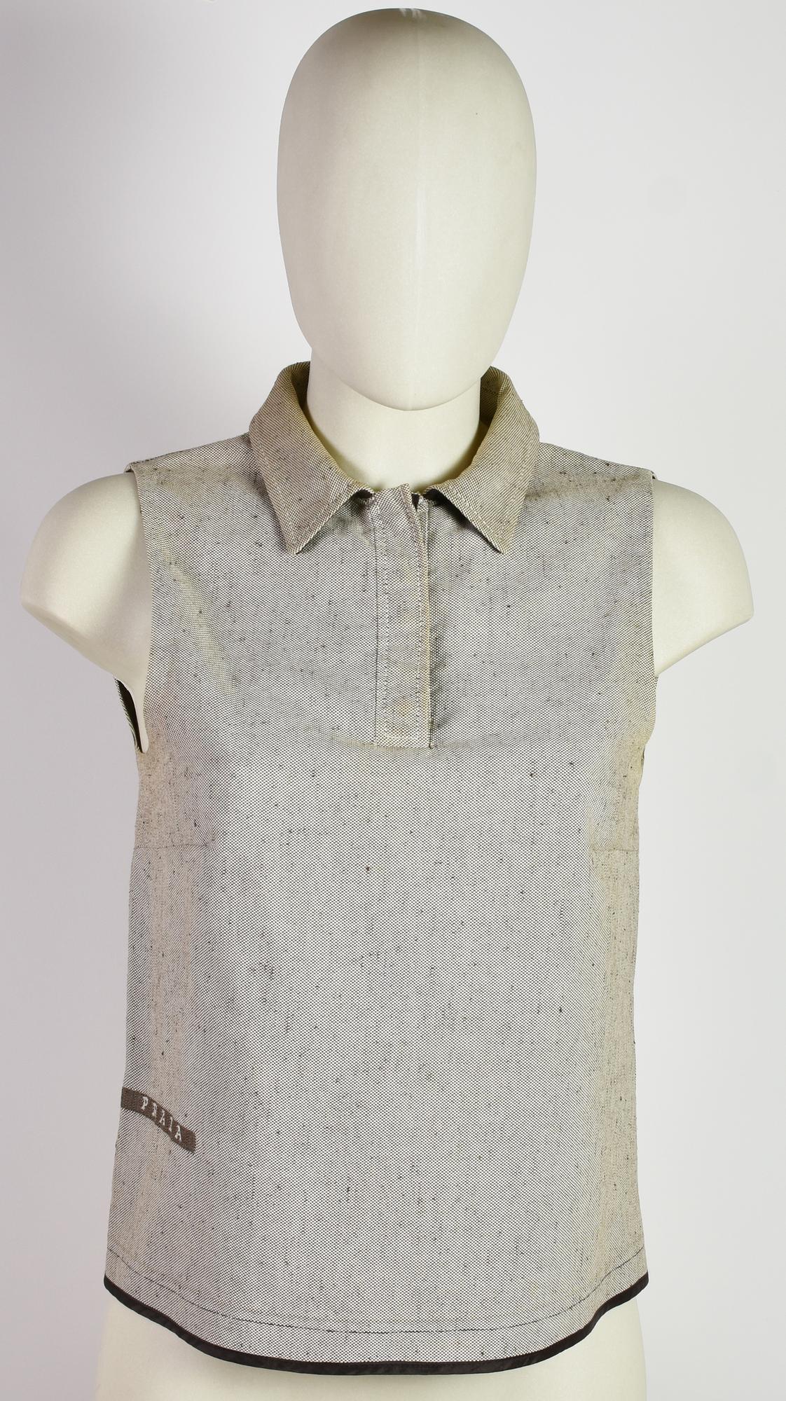 Prada TOP DESCRIPTION: Sleeveless cotton top with contrast leather details....