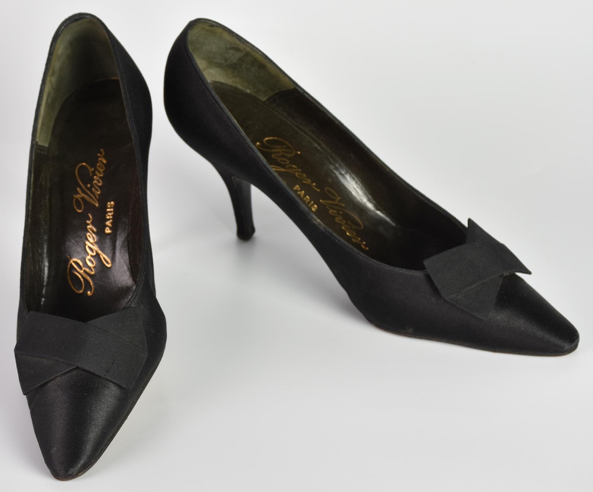 Roger Vivier SHOES DESCRIPTION: Black satin shoes with flat bow. Heels 7.50...