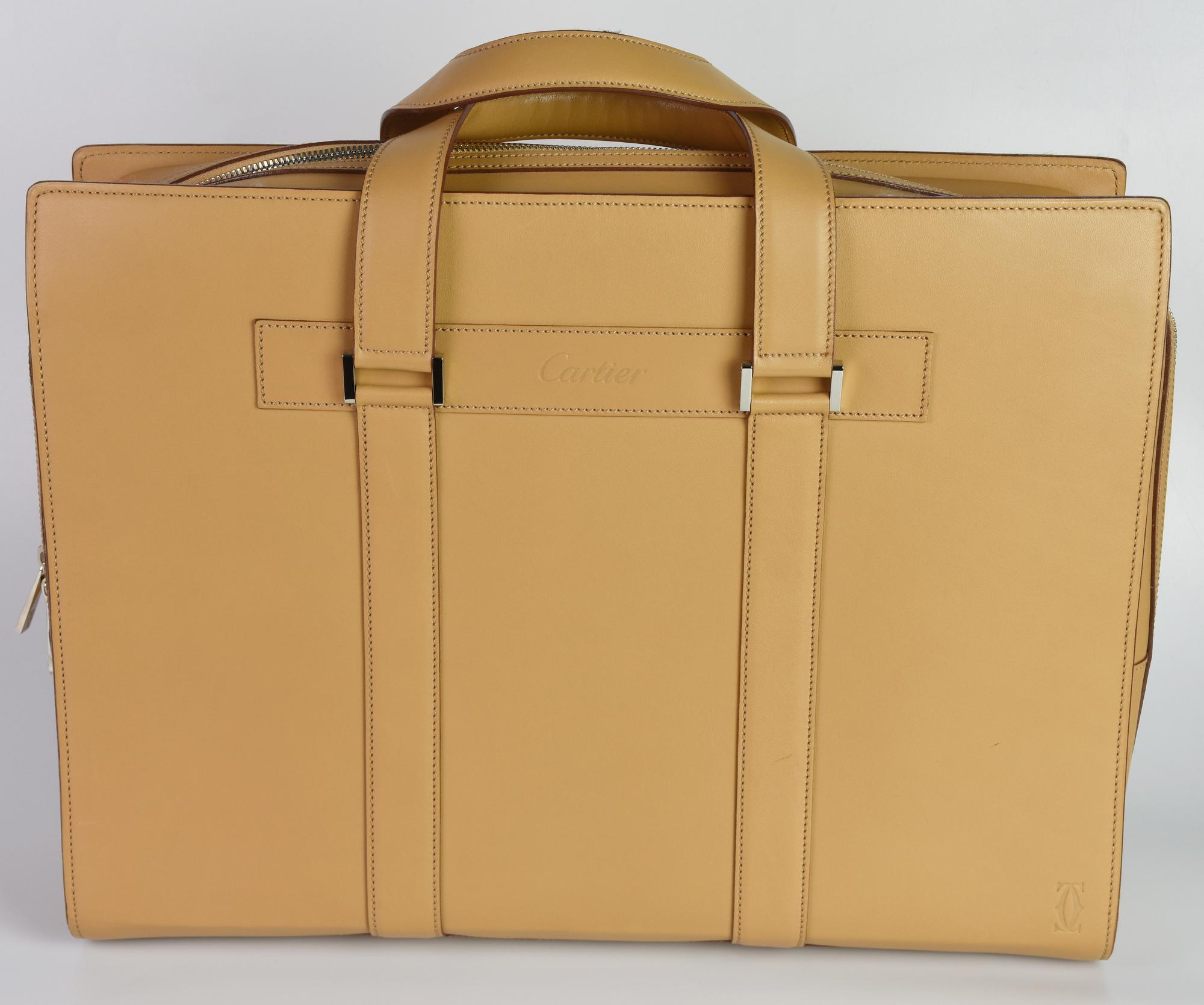 Cartier MUST EN CUIR BRIEFCASE DESCRIPTION: Beige leather briefcase with...