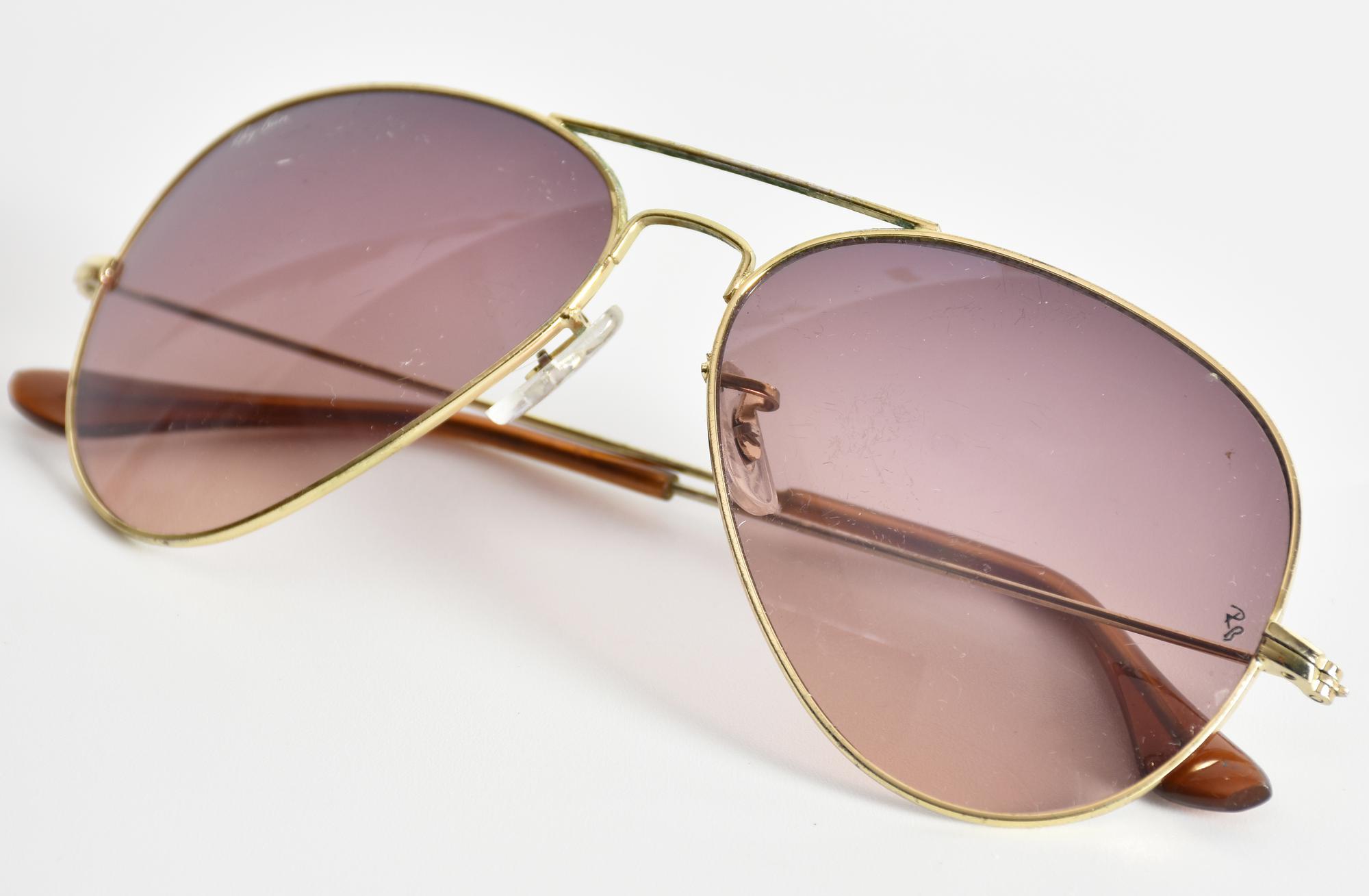 Ray-Ban AVIATOR SUNGLASSES DESCRIPTION: Aviator-style sunglasses. Gold frame...