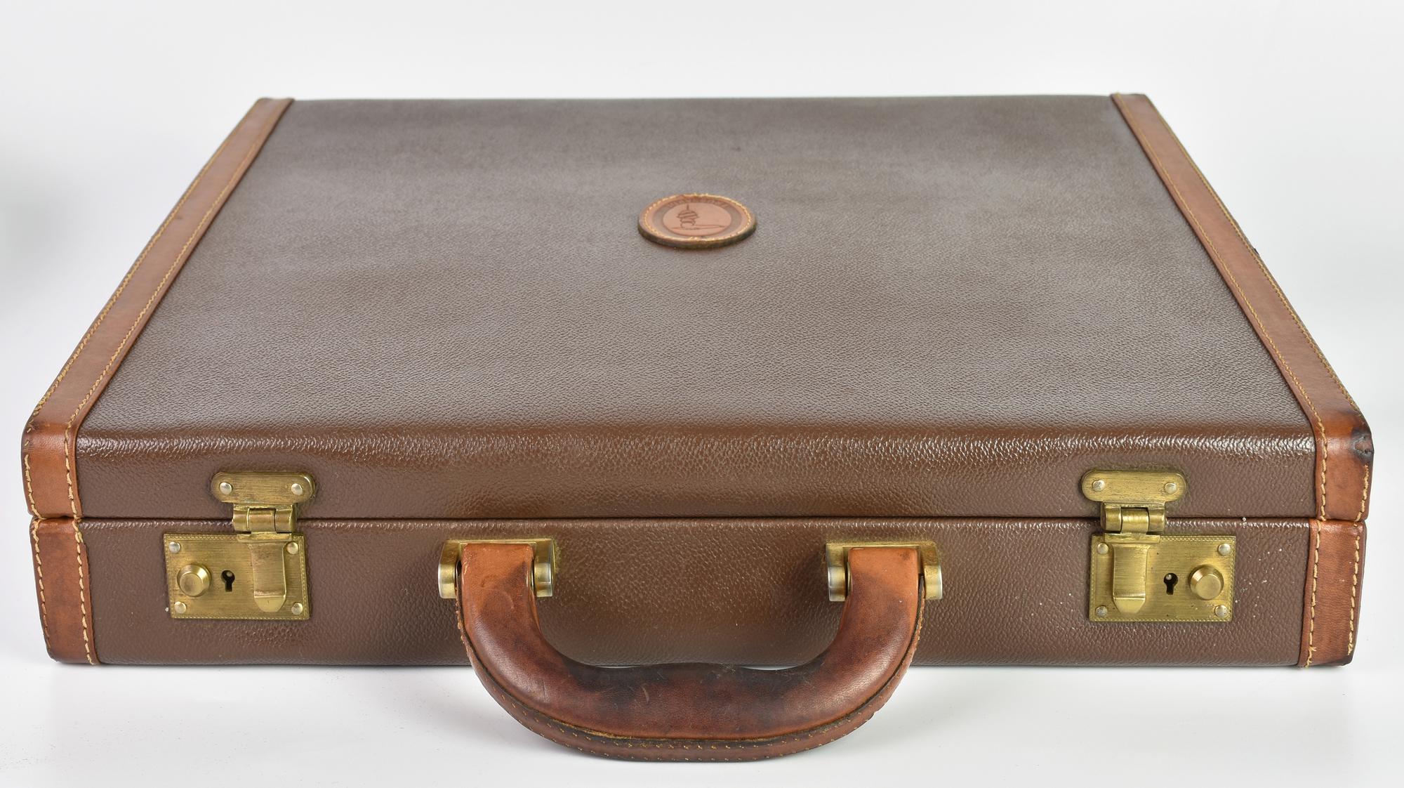 Trussardi BRIEFCASE DESCRIPTION: Brown leather hard case briefcase with snap...