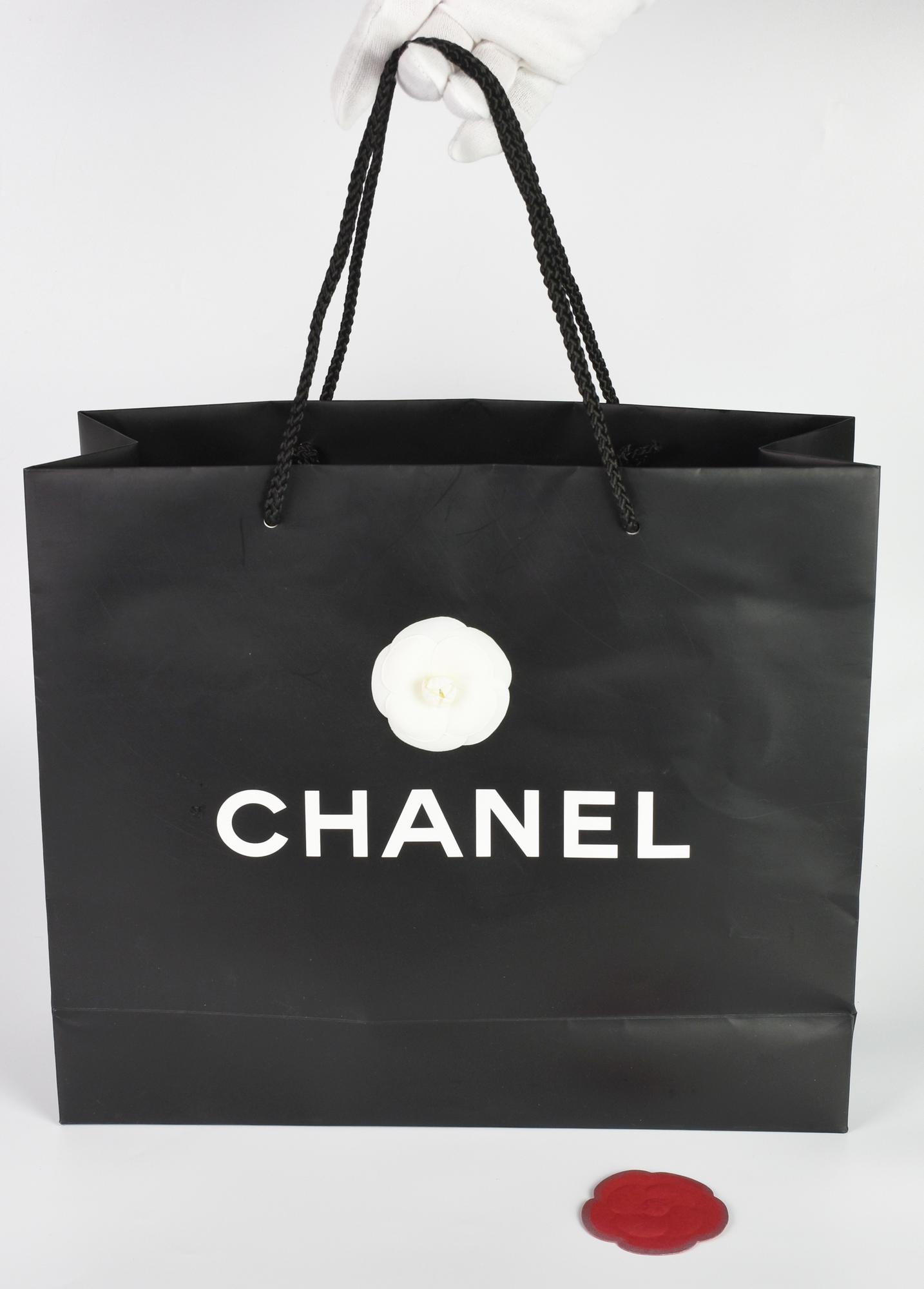 Chanel SHOPPER DESCRIPTION: Chanel paper shopper with two camellias, one...