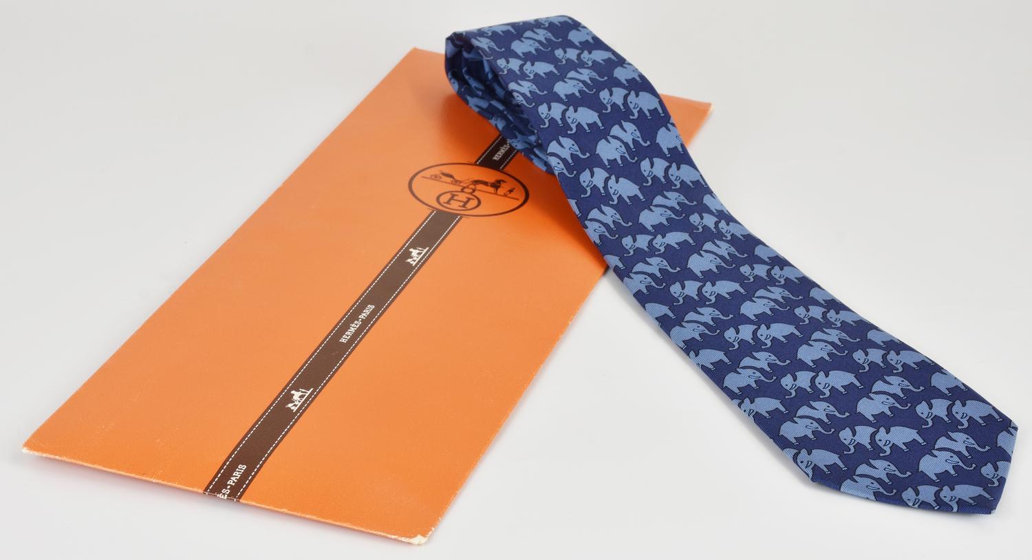 Hermes SILK TIE DESCRIPTION: A silk tie featuring an elephant pattern on a...