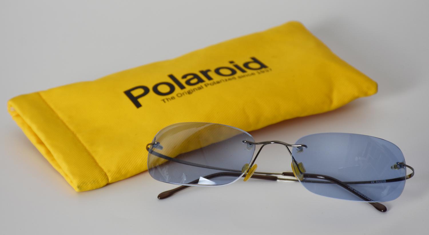 Polaroid SUNGLASSES DESCRIPTION: Sunglasses with blue lenses. Presented with...