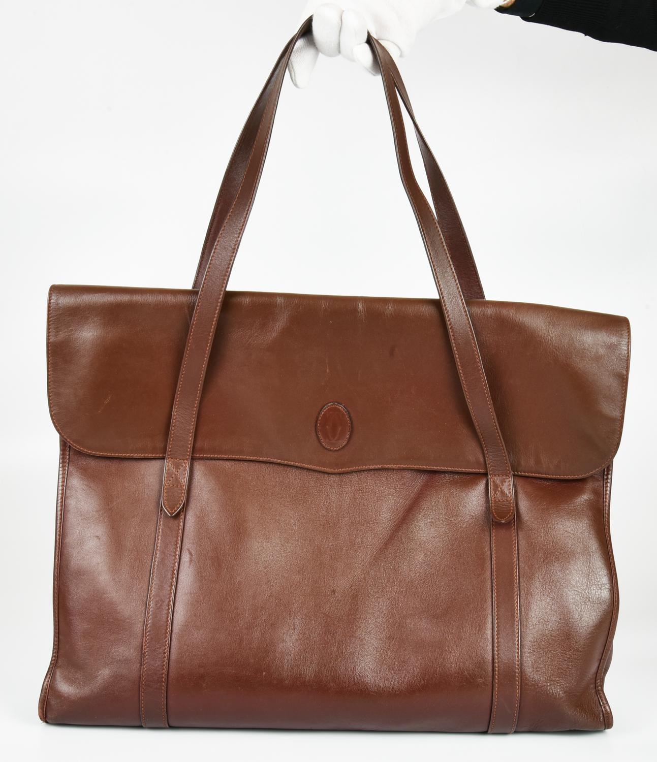 Le Must de Cartier LEATHER BRIEFCASE DESCRIPTION: Work bag in leather,...