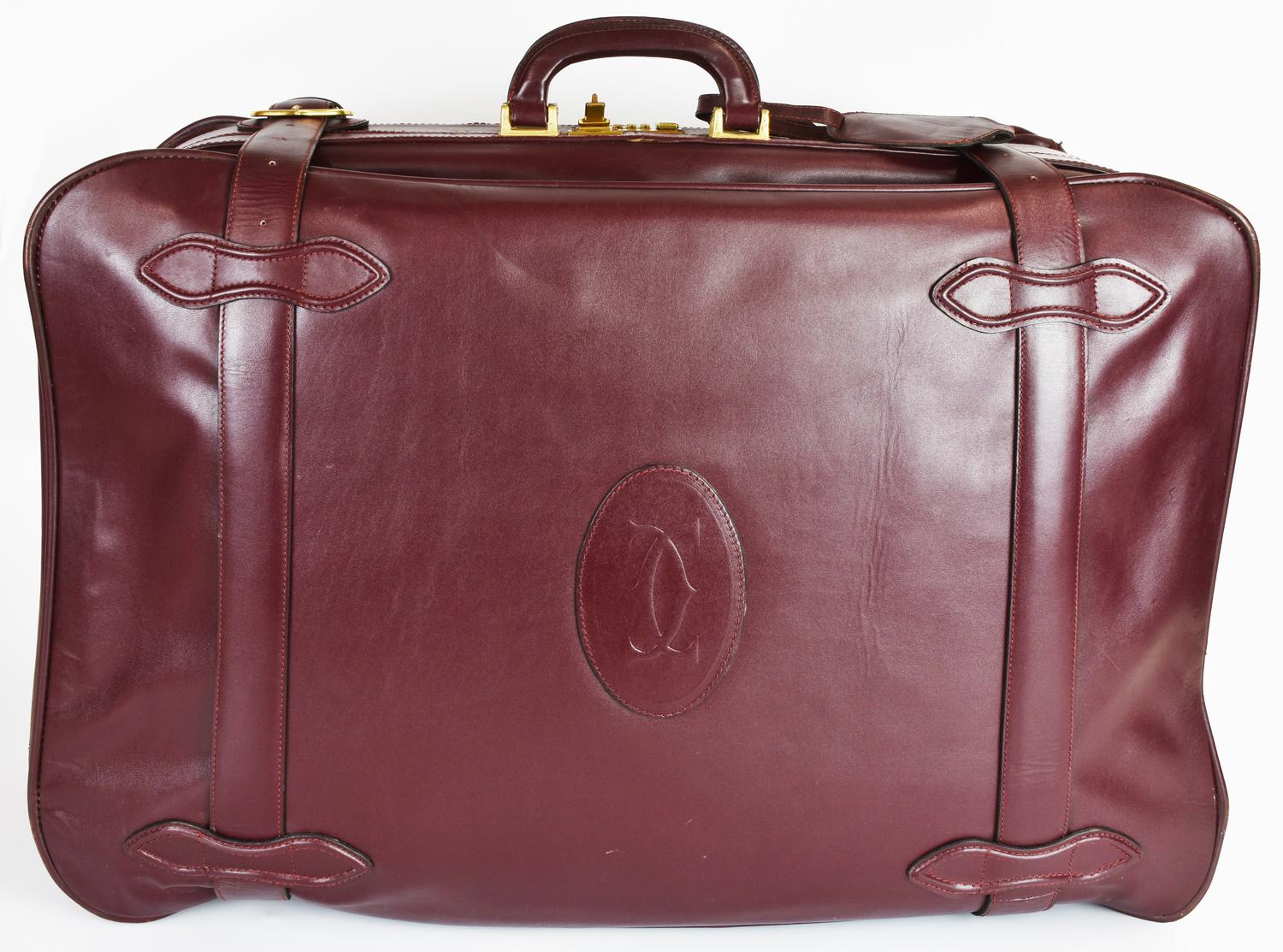 Must de Cartier LARGE SUITCASE DESCRIPTION: Smooth leather suitcase with...